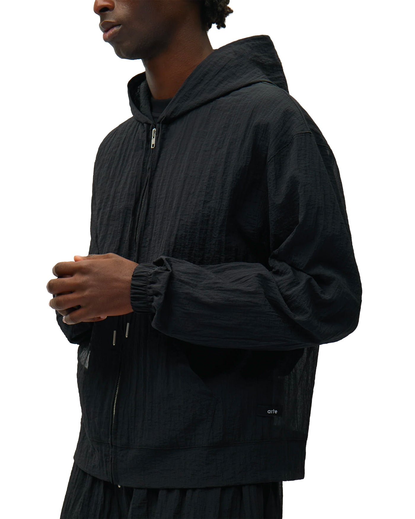 Veste coupe-vent Arte Antwerp noire à capuche zip central profil gauche