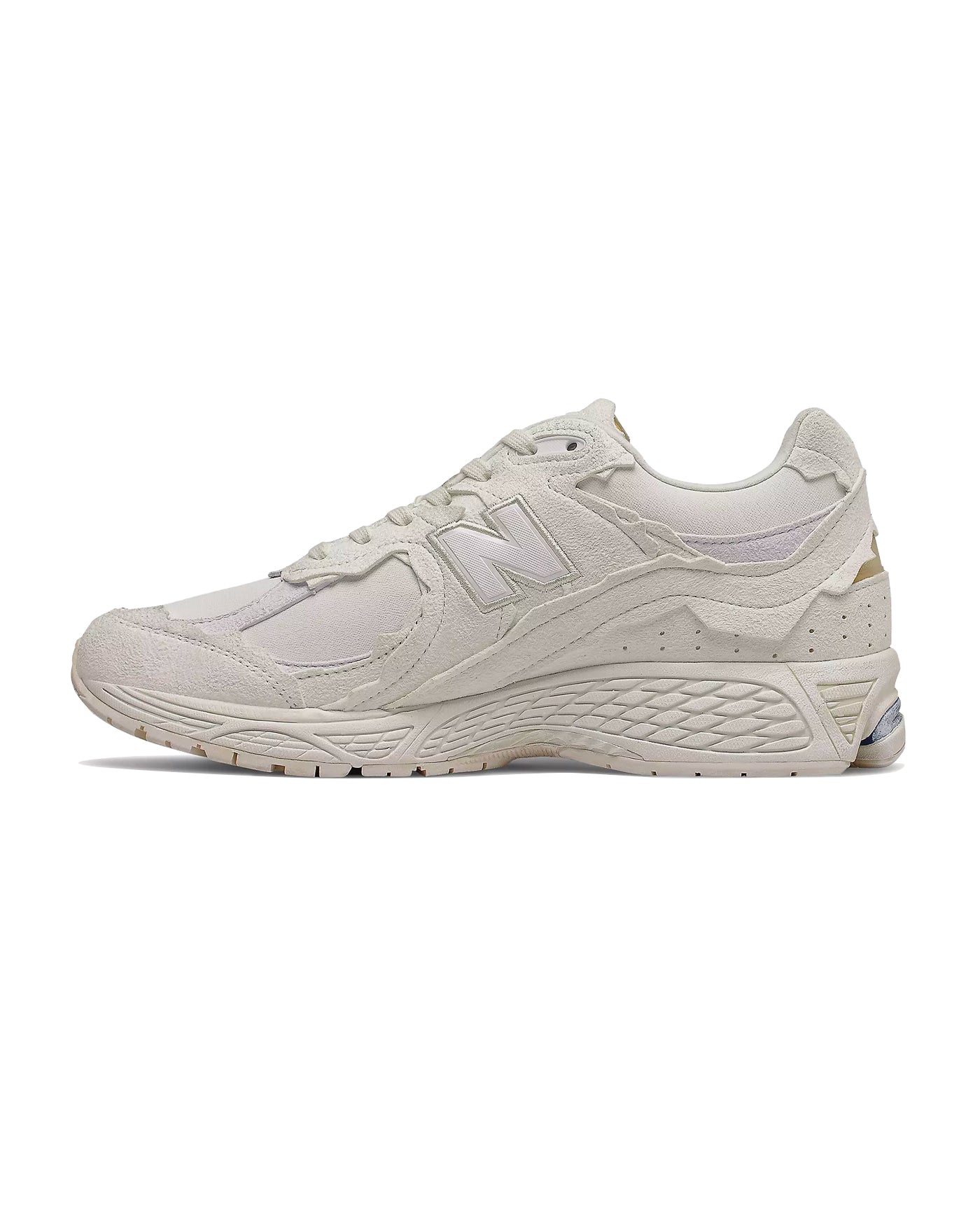 Sneakers New Balance 2002R blanc ivoire détails dorés profil gauche